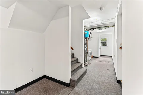 a view of washer and dryer with kitchen in the background