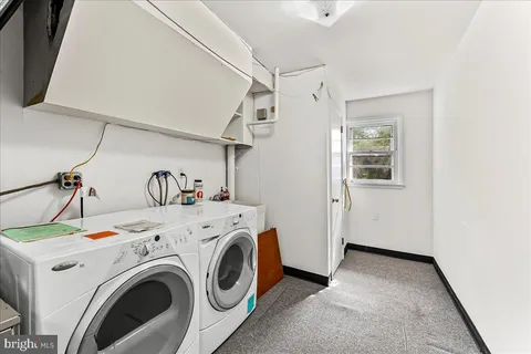 a view of a white house next to a yard