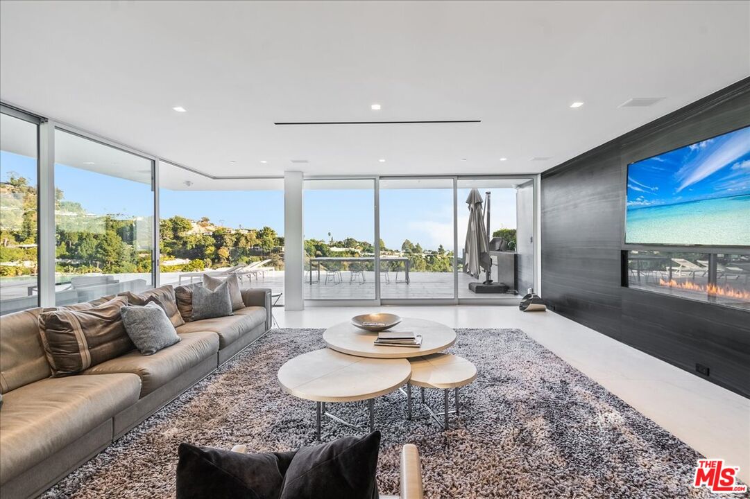 1620 Carla Ridge Beverly Hills, CA 90210 - Photo 13 of 42 a living room with furniture and a large window
