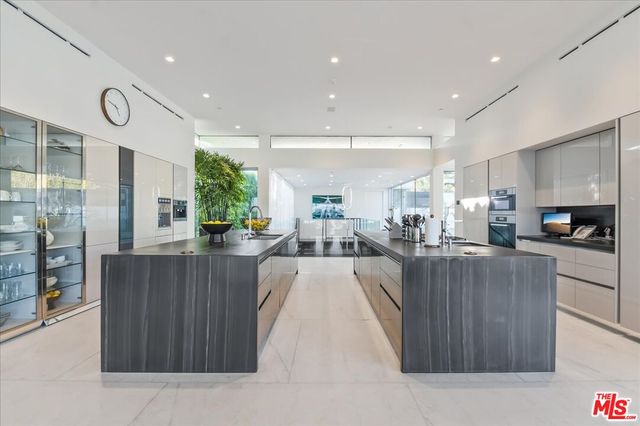 a large kitchen with kitchen island a sink stainless steel appliances and a counter top space