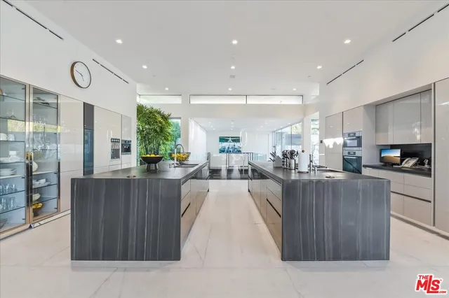 a large kitchen with kitchen island a sink stainless steel appliances and a counter top space