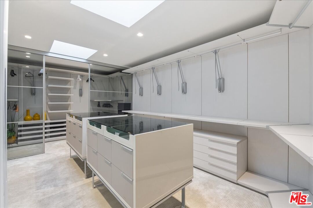 1620 Carla Ridge Beverly Hills, CA 90210 - Photo 25 of 42 a kitchen that has a sink and a stove in it