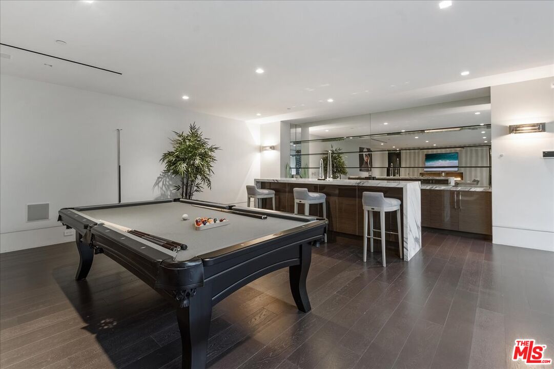 1620 Carla Ridge Beverly Hills, CA 90210 - Photo 31 of 42 a view of a kitchen with kitchen island a stove a table and a refrigerator