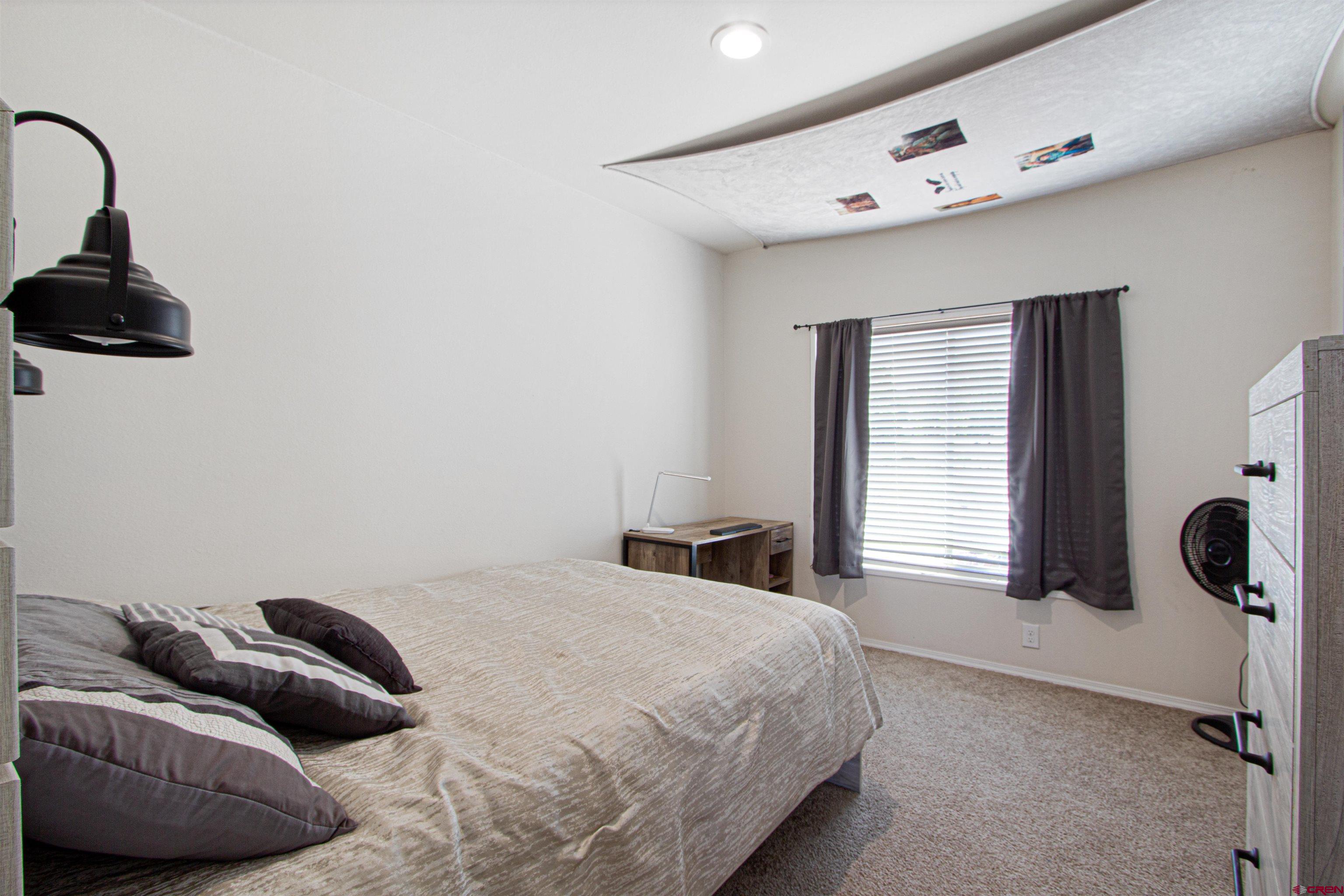 62069 Jade Road Montrose, CO 81401 - Photo 12 of 29 a bedroom with a bed and a window