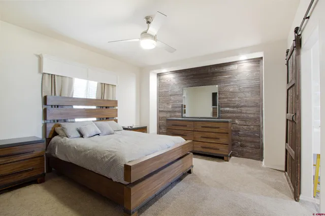 a bedroom with a bed and a television