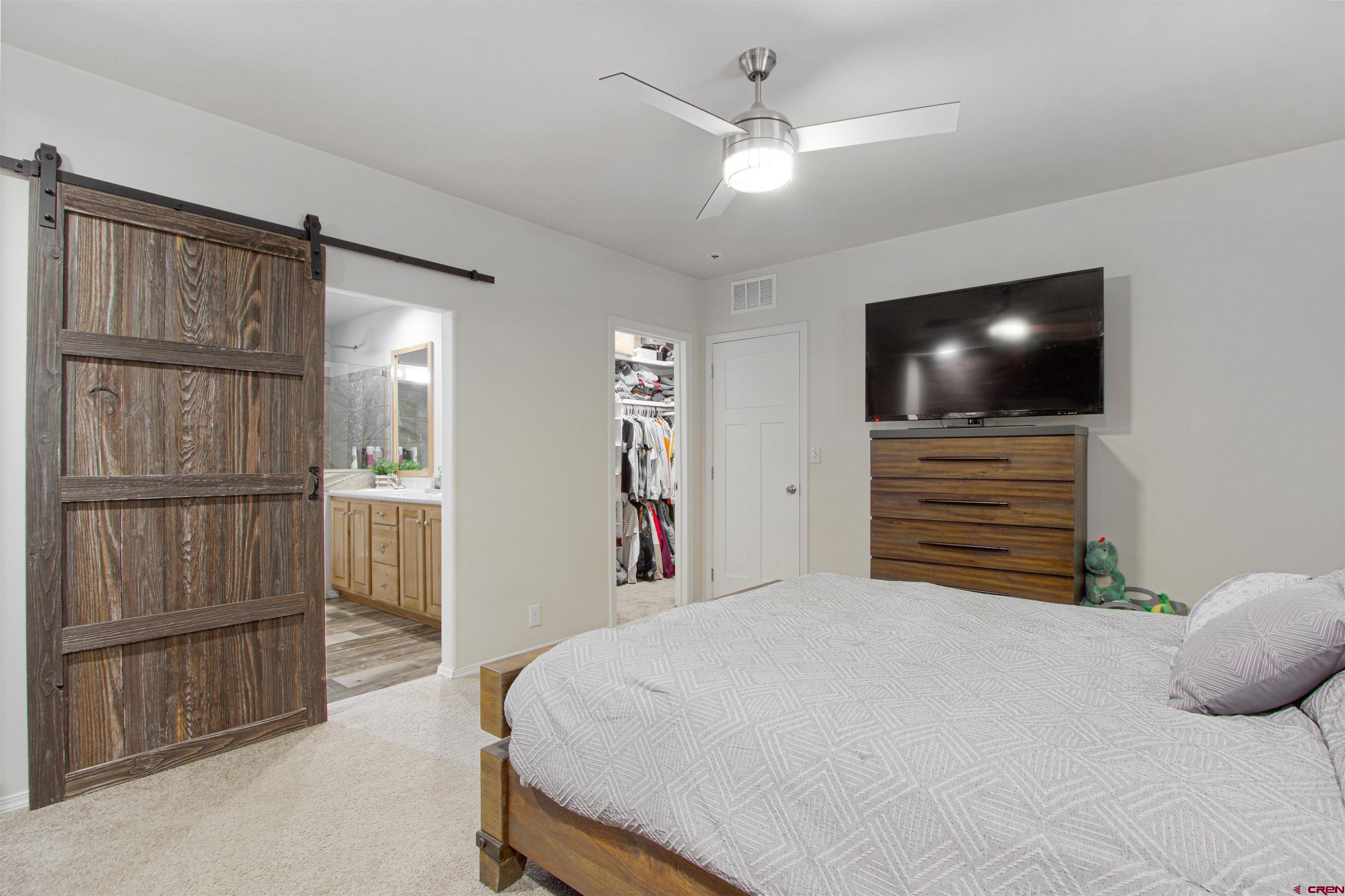 62069 Jade Road Montrose, CO 81401 - Photo 15 of 29 a bedroom with a bed and a television