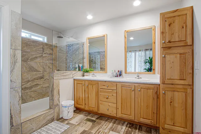 a bathroom with a toilet a sink and shower