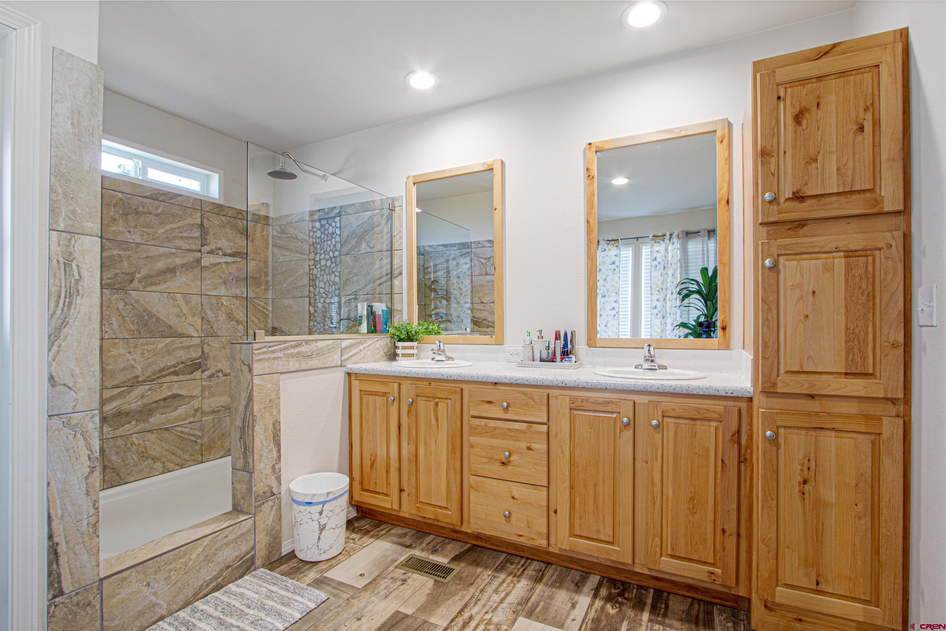 62069 Jade Road Montrose, CO 81401 - Photo 16 of 29 a bathroom with a granite countertop sink toilet and shower