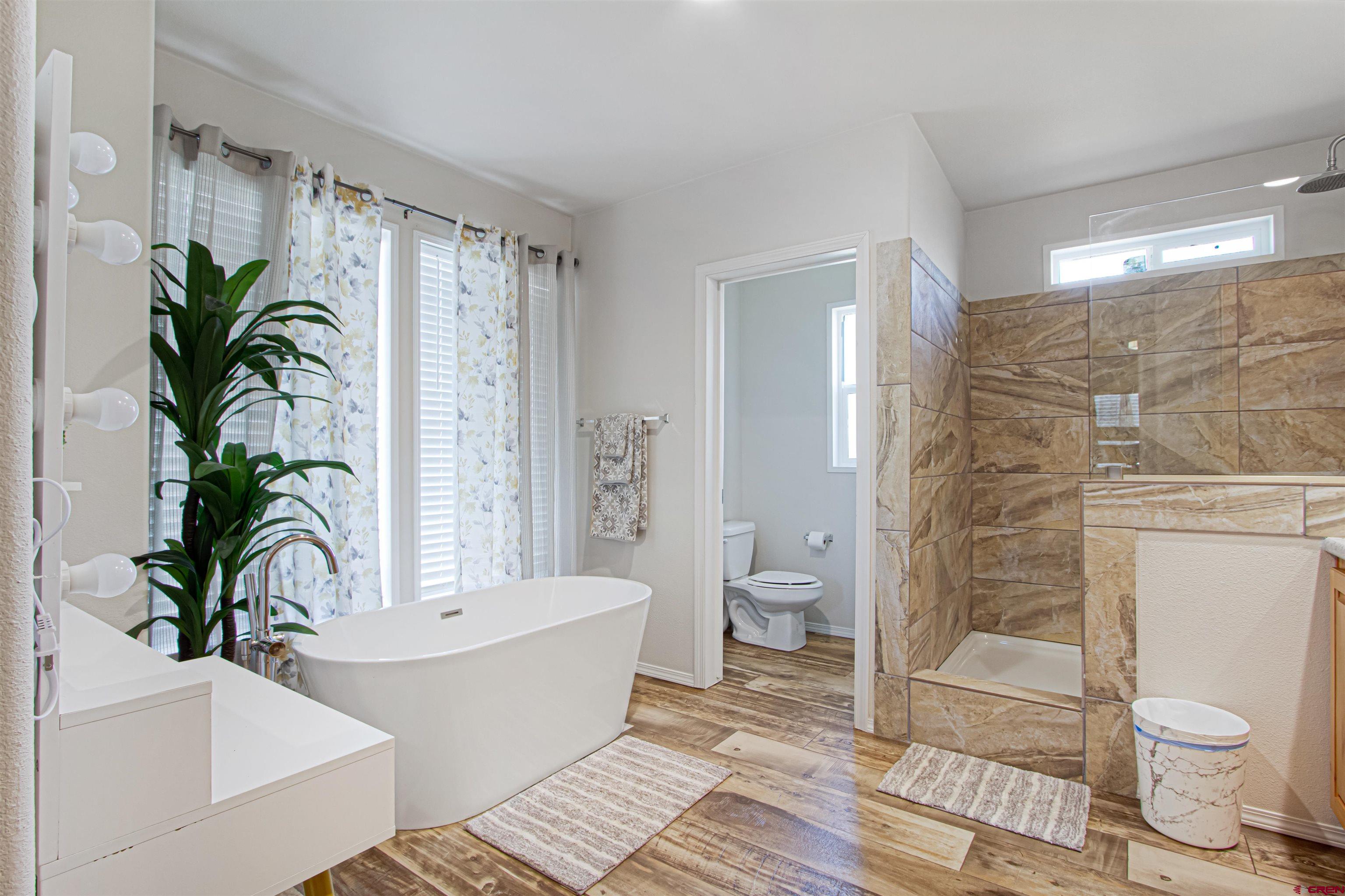 62069 Jade Road Montrose, CO 81401 - Photo 17 of 29 a bathroom with a toilet a sink and shower