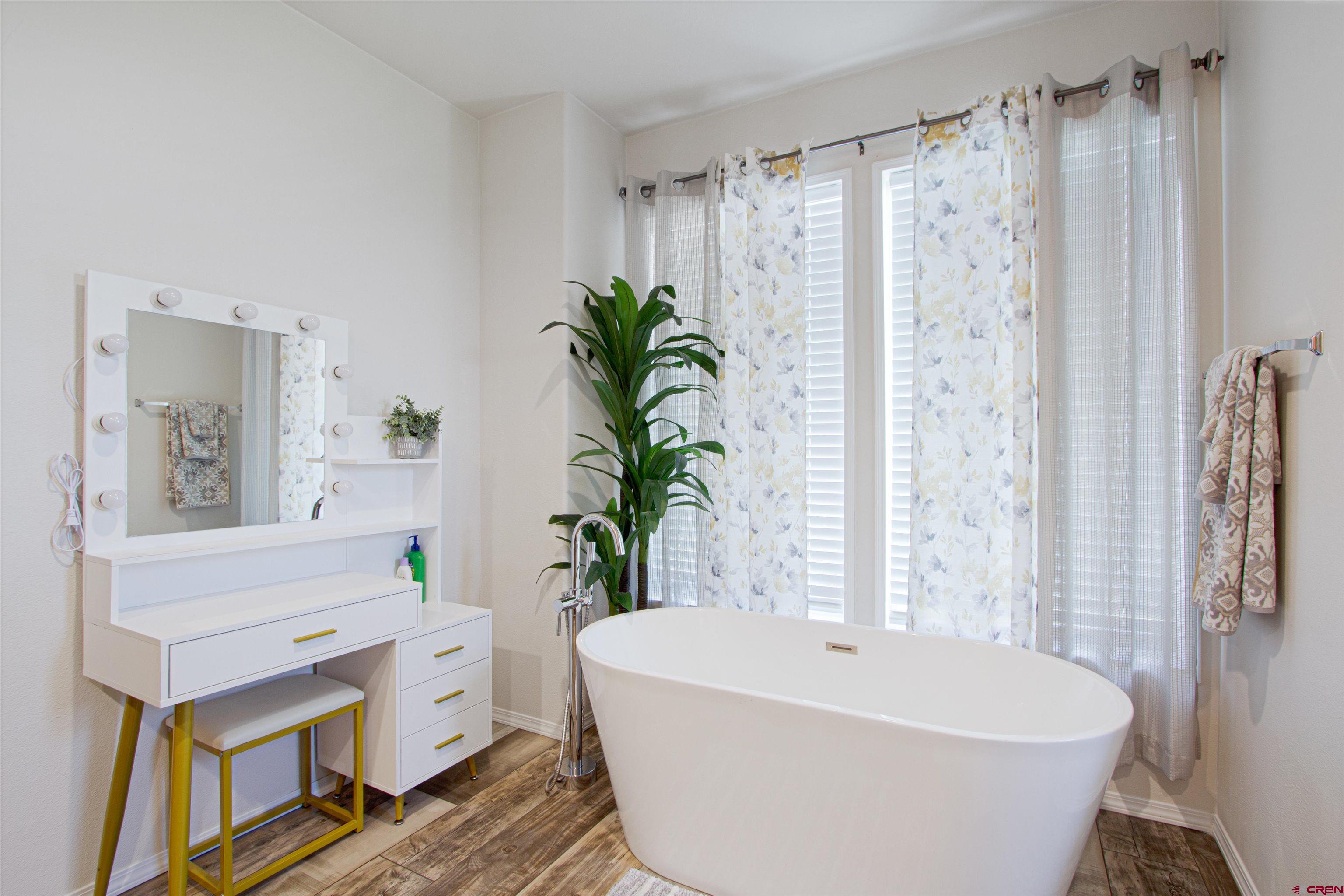 62069 Jade Road Montrose, CO 81401 - Photo 19 of 29 a white bath tub sitting in a bathroom next to a window