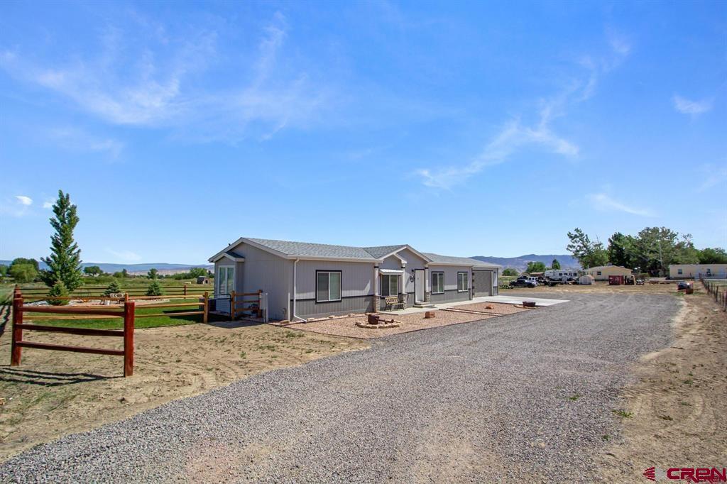 62069 Jade Road Montrose, CO 81401 - Photo 2 of 29 a group of cars parked in front of a house