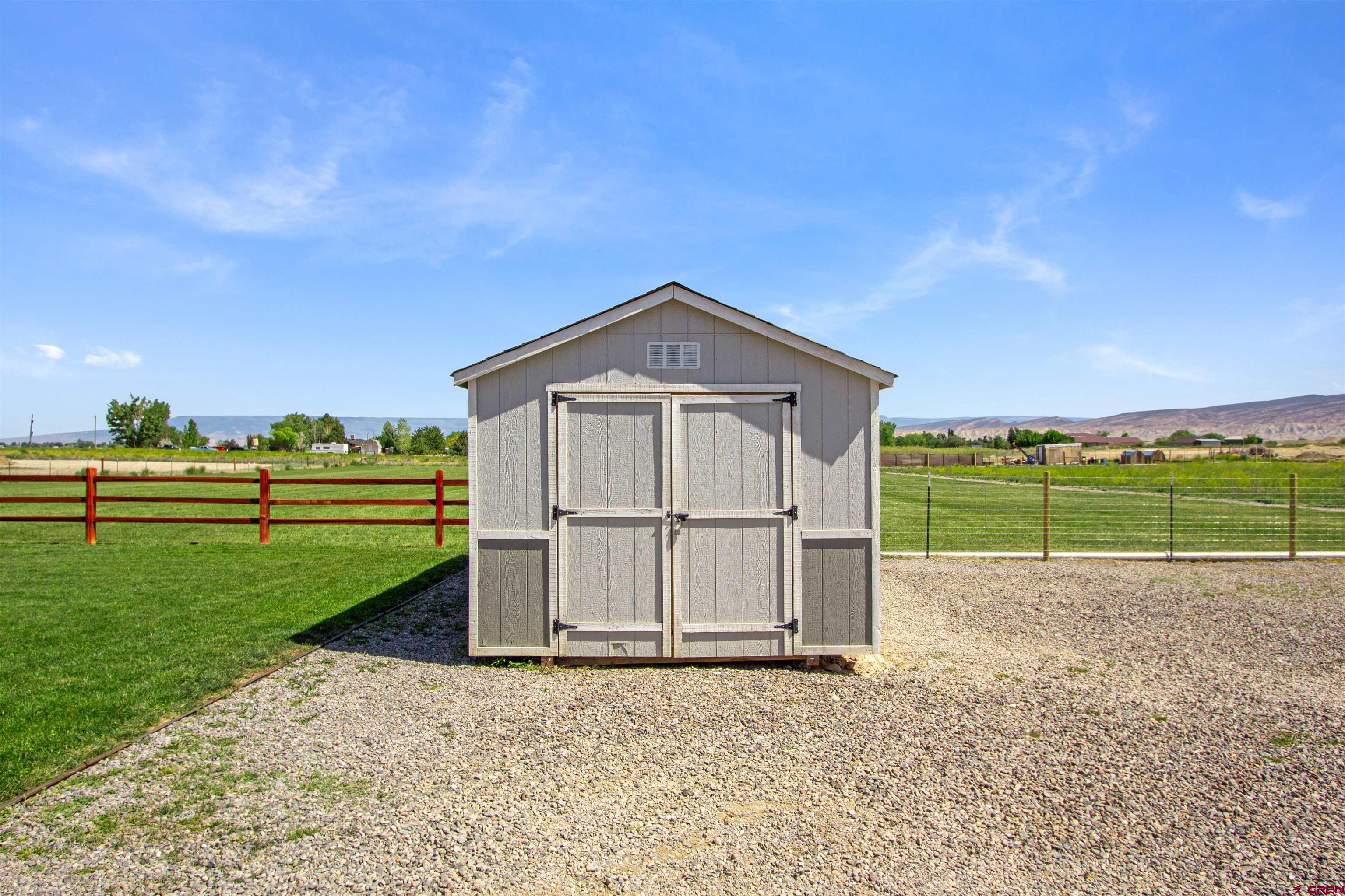 62069 Jade Road Montrose, CO 81401 - Photo 26 of 29 a view of a tiny house with a big yard and large trees