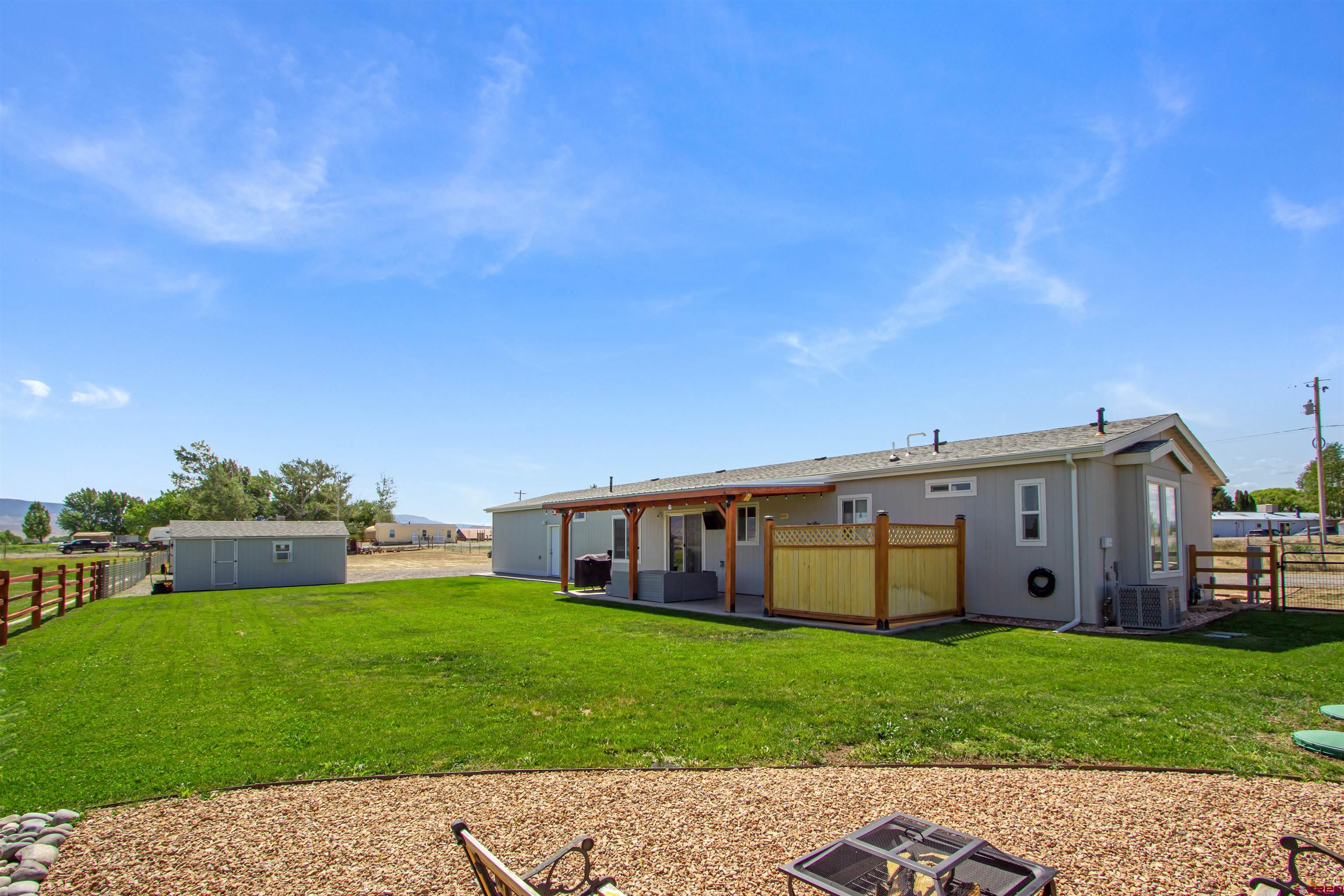 62069 Jade Road Montrose, CO 81401 - Photo 3 of 29 a view of a house with backyard and a garden