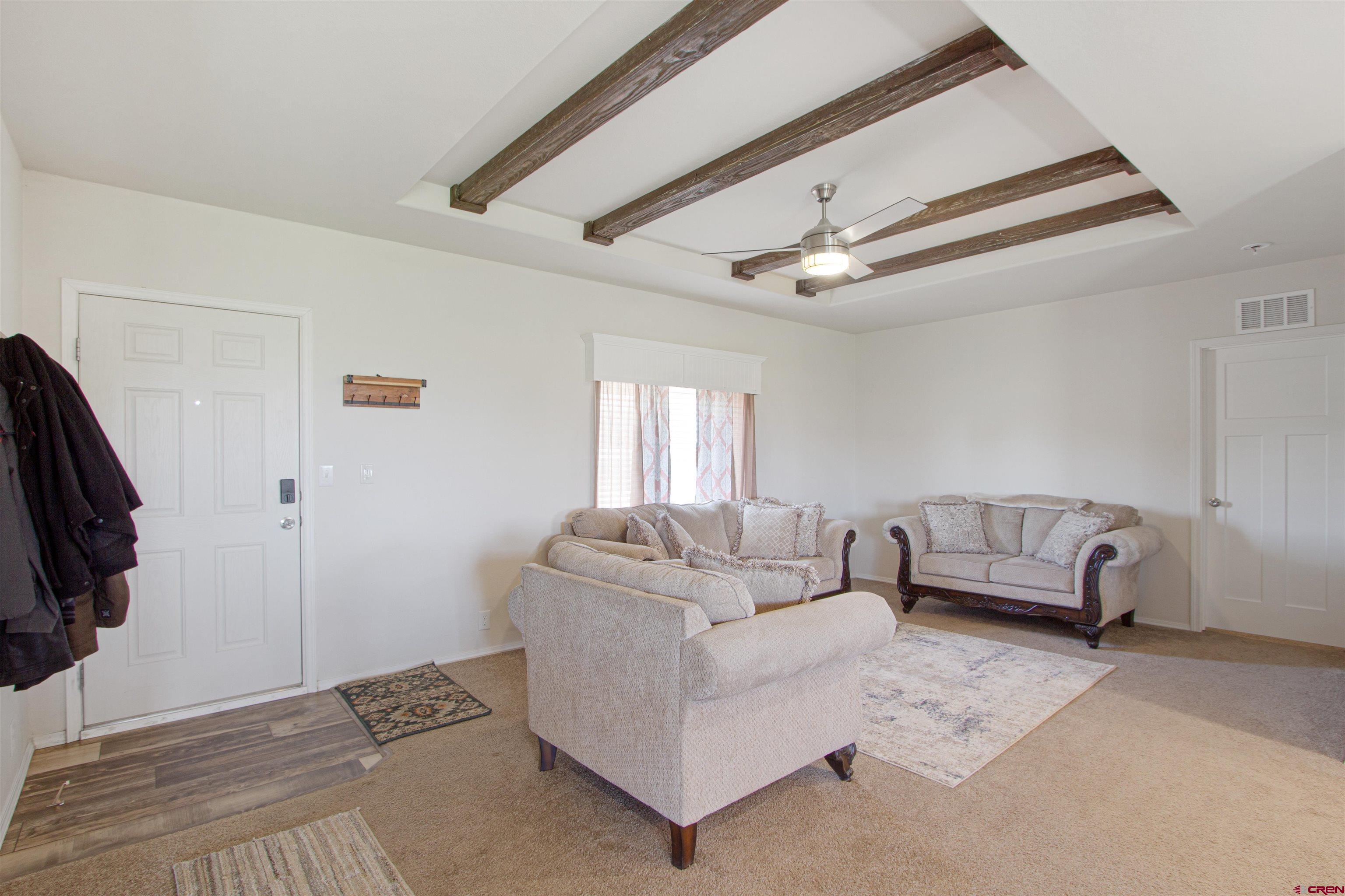 62069 Jade Road Montrose, CO 81401 - Photo 4 of 29 a living room with furniture and a flat screen tv
