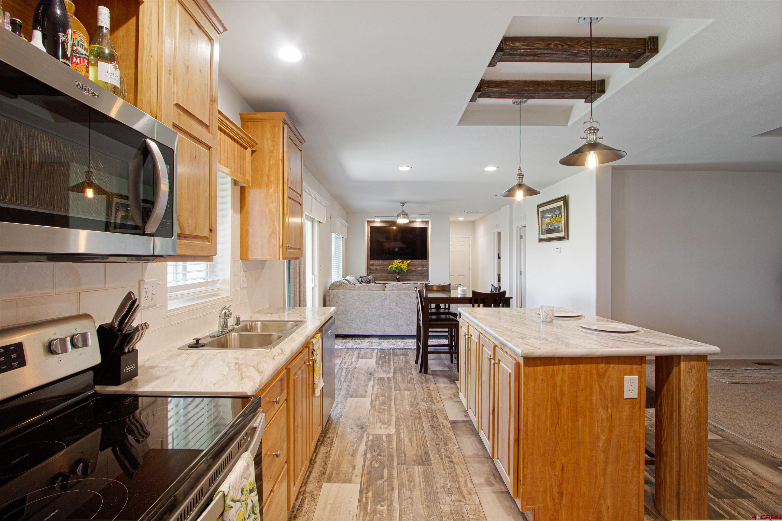 62069 Jade Road Montrose, CO 81401 - Photo 5 of 29 a kitchen with stainless steel appliances granite countertop a sink stove and refrigerator