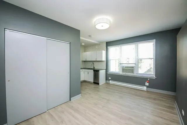 a view of a room with window and wooden floor