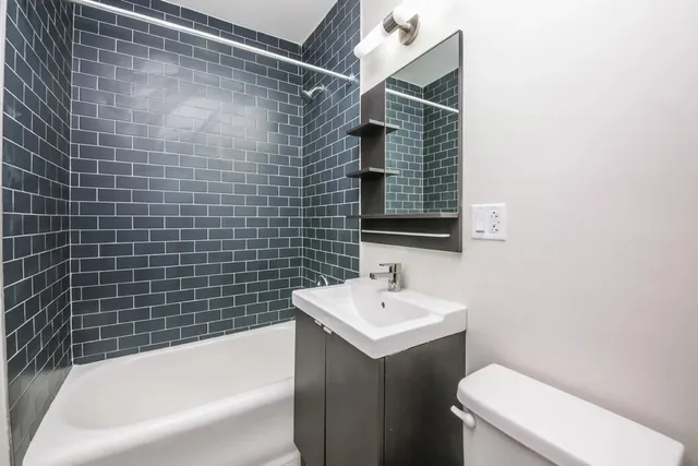 a bathroom with a sink mirror bathtub and toilet
