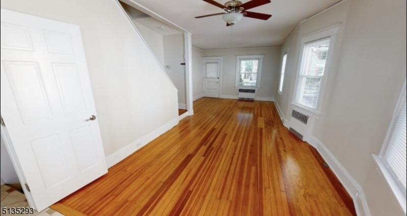 40-42 Dunnell Road Maplewood, NJ 07040 - Photo 3 of 11 a view of a hallway with wooden floor and staircase