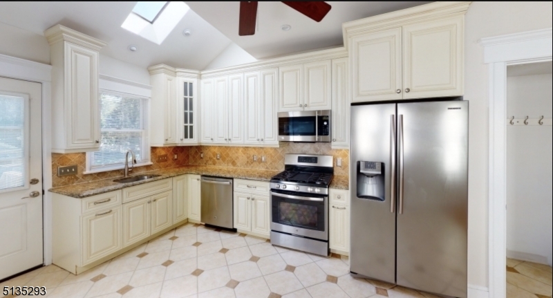 40-42 Dunnell Road Maplewood, NJ 07040 - Photo 4 of 11 a kitchen with stainless steel appliances granite countertop a stove a sink and a refrigerator