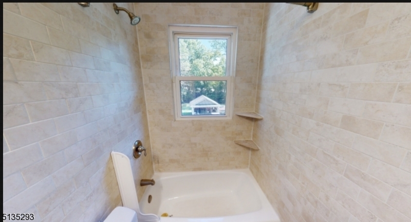 40-42 Dunnell Road Maplewood, NJ 07040 - Photo 8 of 11 a bath tub sitting next to a white toilet