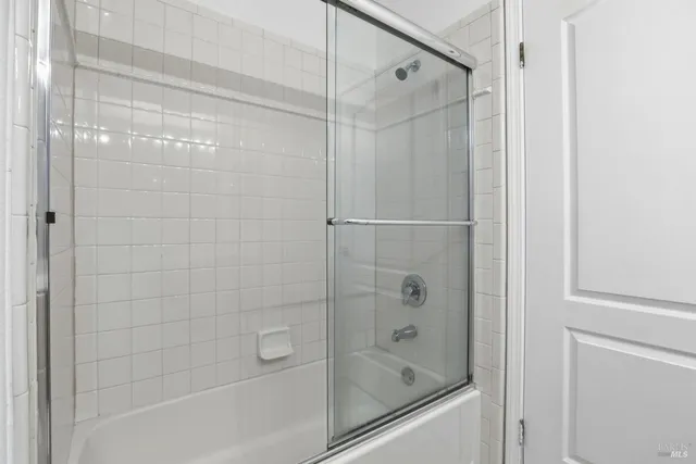 a bathroom with a shower and a bath tub