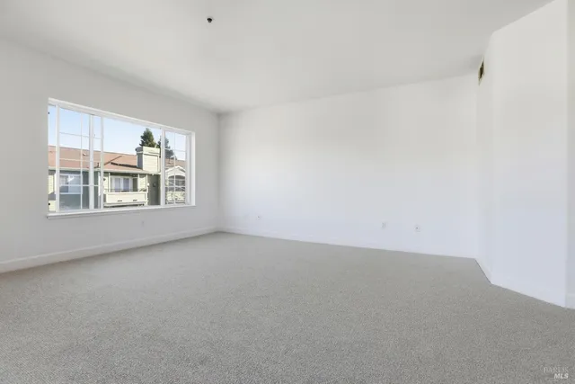 a view of an empty room with windows