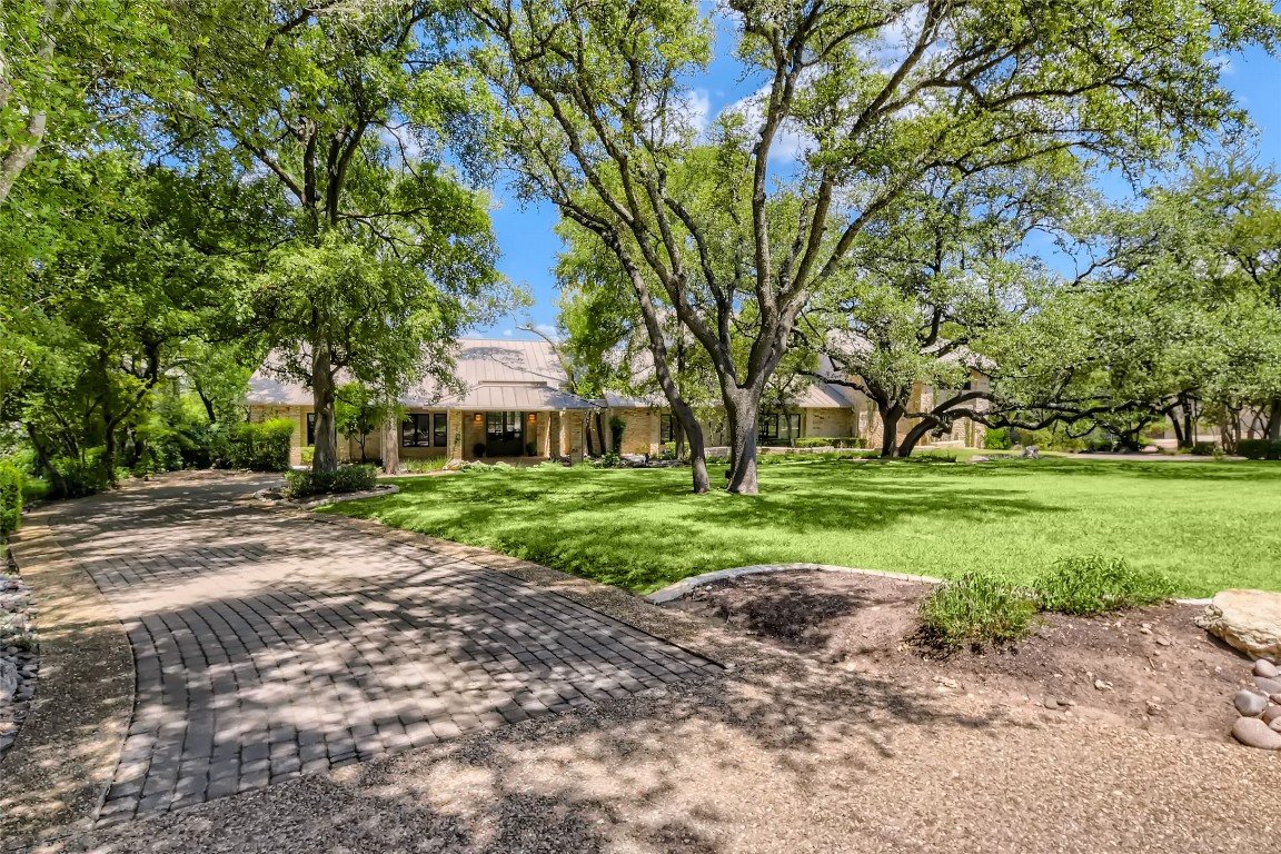 78 St Stephens School Road Austin, TX 78746 - Photo 1 of 1 a front view of a house with a yard