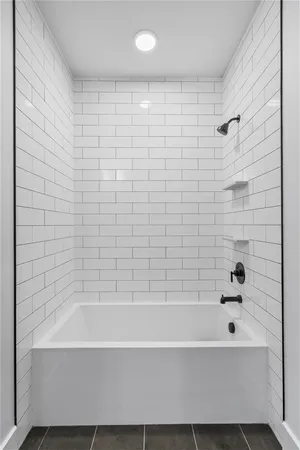 a bathroom with a bathtub and shower