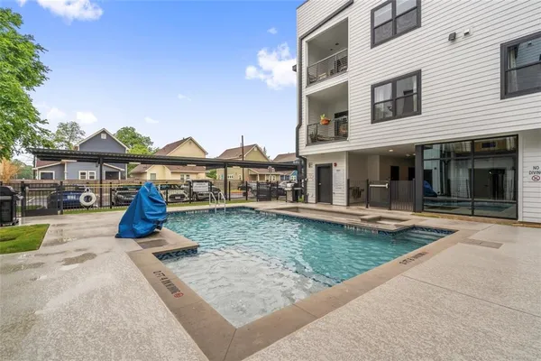 a view of a house with a yard patio and fire pit