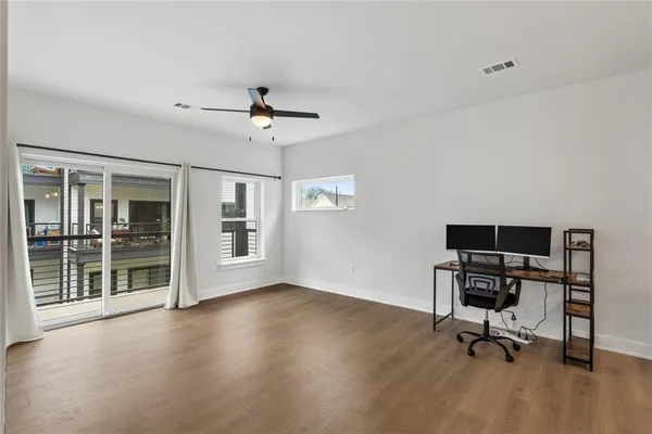 a view of a workspace with furniture and a window
