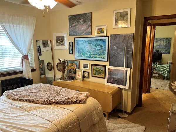 a bed sitting in a bedroom next to a window