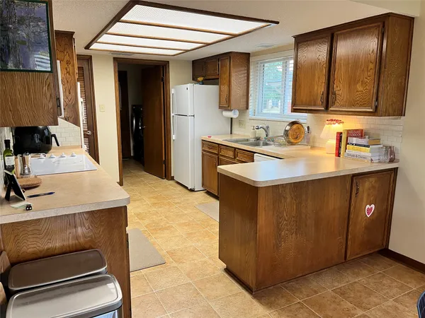 a kitchen with a sink cabinets and refrigerator