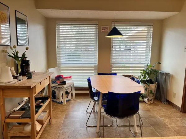 a view of a dining room with furniture and window