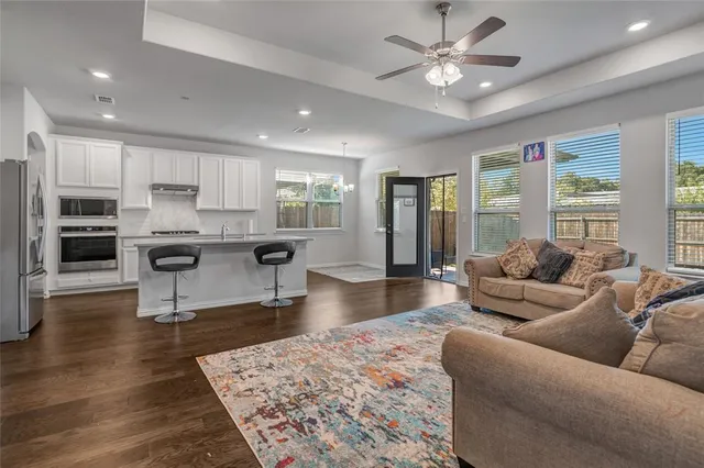 a living room with furniture and a wooden floor
