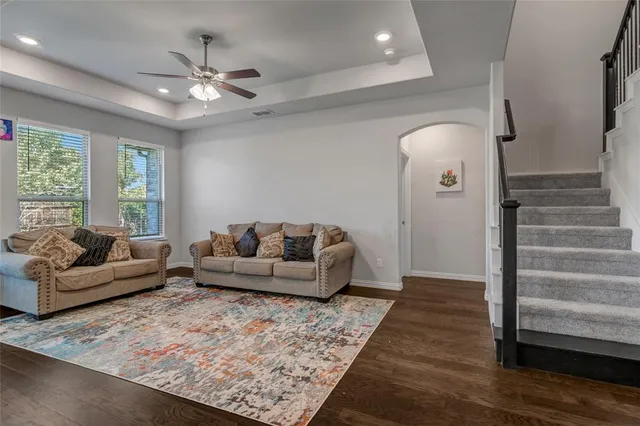 a living room with furniture and a chandelier
