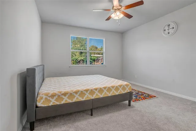 a bed sitting in a bedroom next to a window