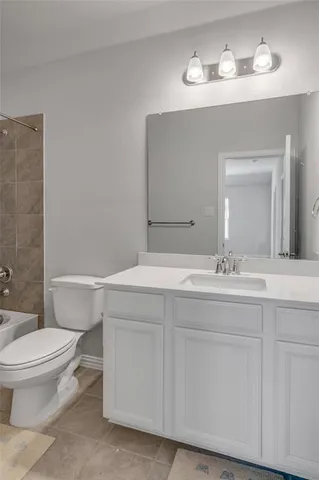 a bathroom with a sink toilet and a mirror