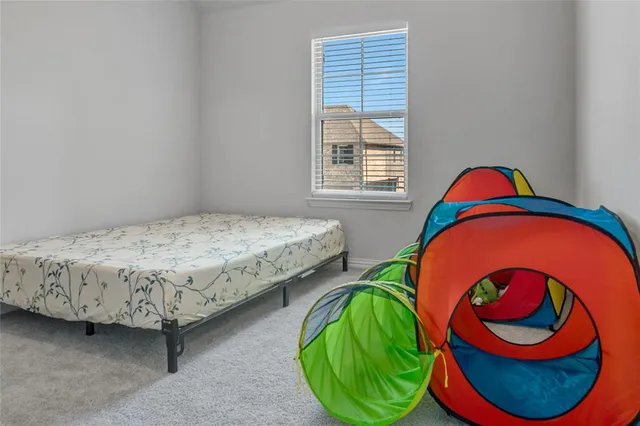 a bedroom with 2 bed and a window