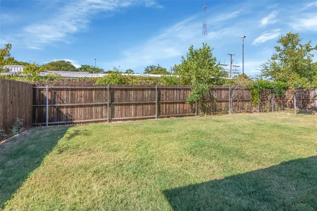 a view of a garden with a building in the background
