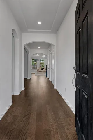 a view of a hallway with wooden floor