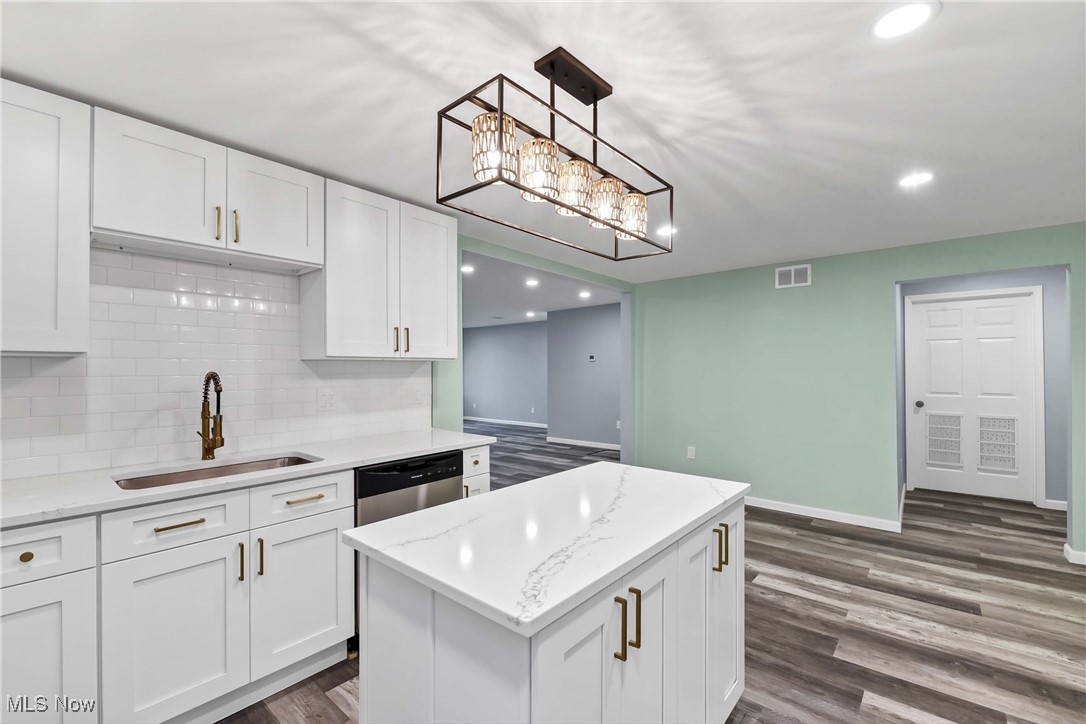2022 Rohde Street Sandusky, OH 44870 - Photo 10 of 29 Kitchen with LVT flooring, sink, white cabinets, and stainless steel dishwasher