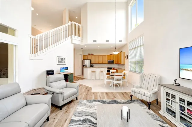 a living room with furniture and a chandelier