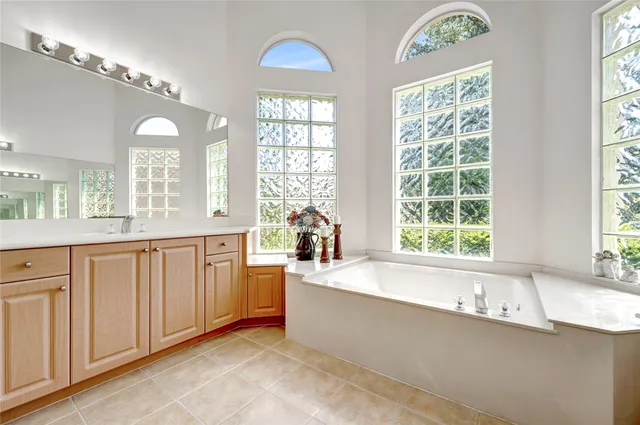 a large white kitchen with a large window