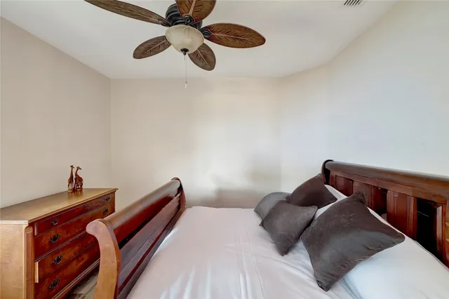 a bedroom with a bed and ceiling fan