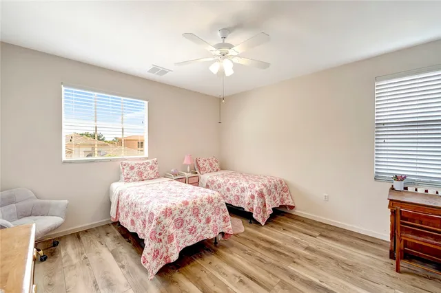 a bedroom with two beds and a chandelier