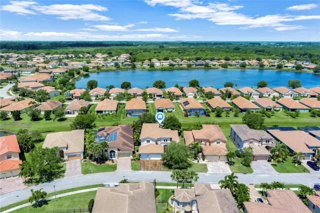 an aerial view of a house with a lake view