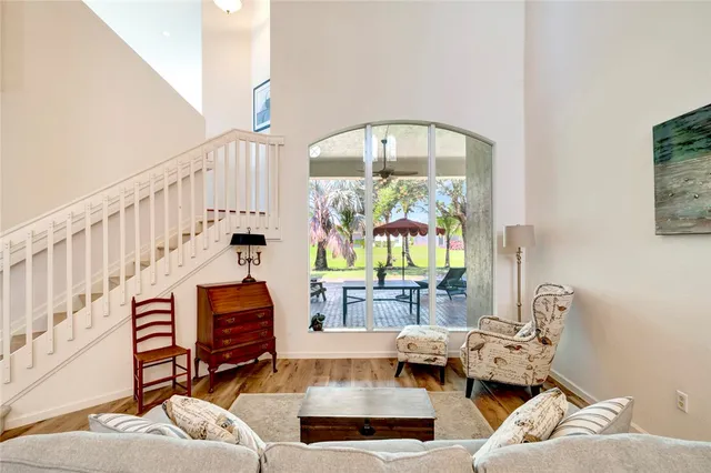 a living room with furniture fireplace and a large window