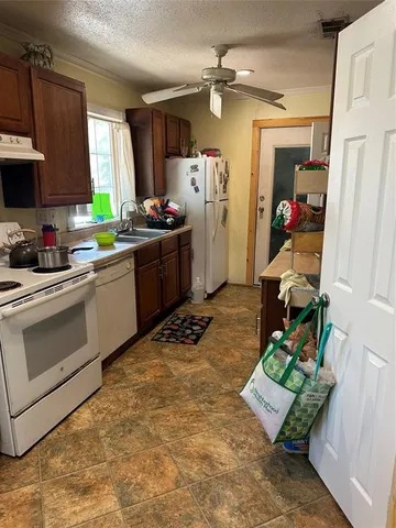 a kitchen with stainless steel appliances granite countertop a sink dishwasher stove and refrigerator