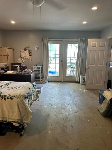 a spacious bedroom with a bed and a couch