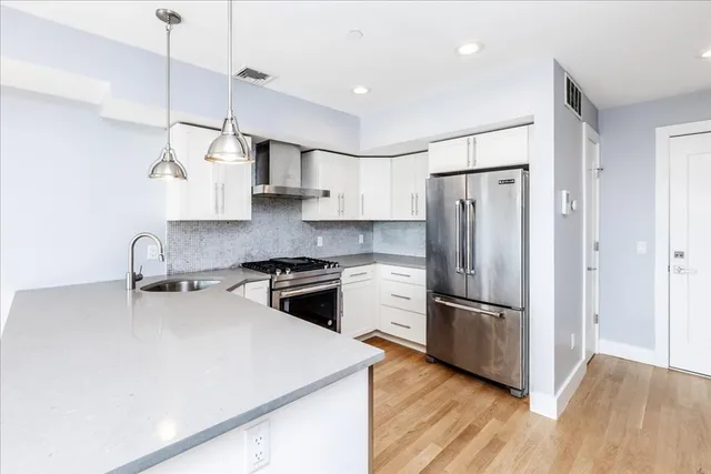 a kitchen with a stove a sink and a refrigerator